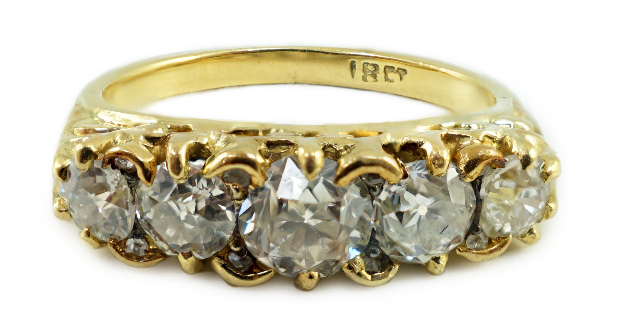 An 18ct gold and graduated five stone diamond set half hoop ring